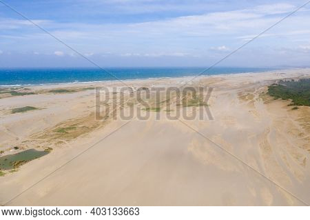 The Sand Dunes Of Paoay, Ilocos Norte, Philippines. Landscape With Trees And Sand Hills Near The Oce