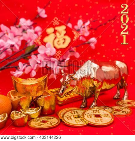 2021 is year of the ox,Chinese characters on rightside chinese wording and seal mean:Chinese calendar for the year.Chinese characters on gold ingot translation: good bless for money.