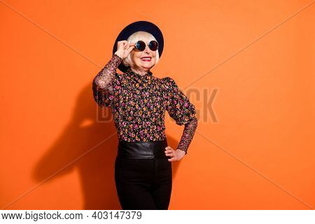 Photo Of Good Mood Happy Smiling Positive Old Woman Look Copyspace Wear Sunglasses Isolated On Orang