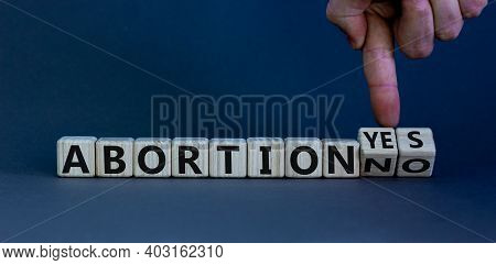 Abortion Yes Or No Symbol. Male Hand Turns Wooden Cubes And Changes Words 'abortion Yes' To 'abortio