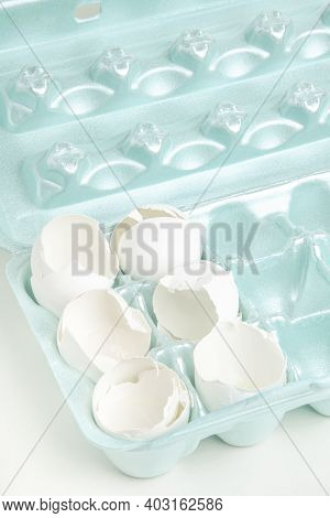 A Close-up Of A Set Of Cracked White Egg Shells Individually Nestled On Cores Of Styrofoam Tray.