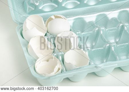 A Close-up Of A Set Of Cracked White Egg Shells Individually Nestled On Cores Of Styrofoam Tray.
