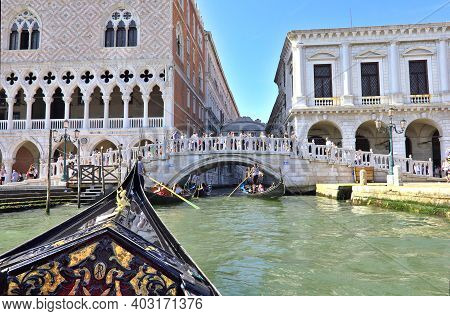 Venice, Italy - 3 August, 2016: Tourists Enjoying The Gondolas In The Canals Near The Bridge Of Sigh