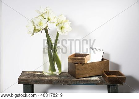 Bouquet Of White Lilies In A Tall Glass Vase On A Beige Table Against A Gray Wall. Copy Space. Fresh