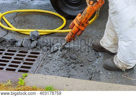 Jackhammer With A Pneumatic Drill Perforating The Asphalt Of An Urban Road Being Renovated On A Stre