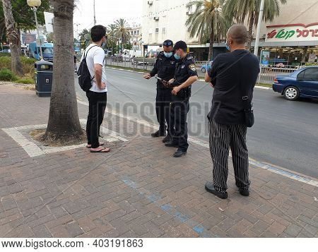 Holon, Israel. July 6, 2020. Israeli Police Officers Giving Out Fine Reports To Israelis Without Pro
