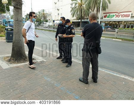 Holon, Israel. July 6, 2020. Israeli Police Officers Giving Out Fine Reports To Israelis Without Pro