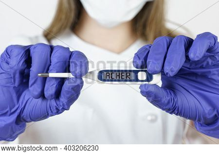 Medicine And Health Concept. The Doctor Holds A Thermometer In His Hands, On The Electronic Screen O