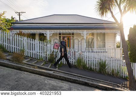 Man Walking In The Steepest Street In The World. Baldwin Street In Dunedin, New Zealand. November 20