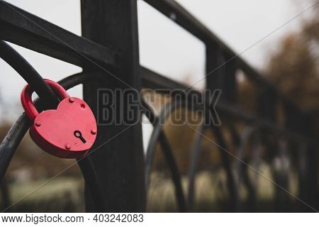 Red Heart Shaped Keylock On A Fence