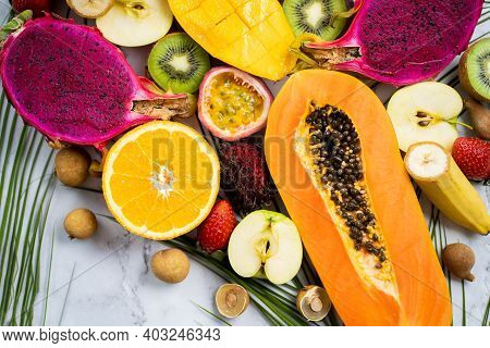 Exotic Fruits And Tropical Leaves On Table
