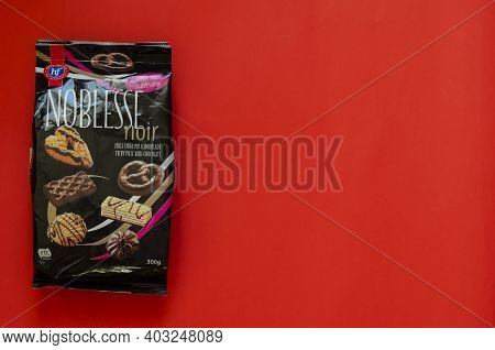Hans Freitag's Noblesse Noir, Assortment Of Biscuits & Wafers Dark Chocolateon Red Background - Ukra