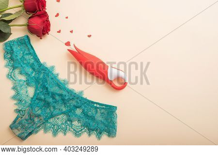 Womens Green Lace Panties, A Bouquet Of Scarlet Roses, A Clitoral Vibrator And Hearts On A Beige Bac