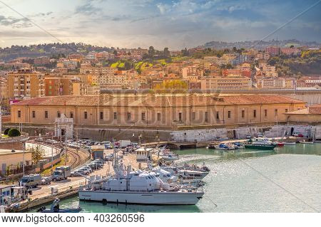 Ancona, Italy, Sunset Harbor View With The Rows Of The Boats Docked And Town On The Hill
