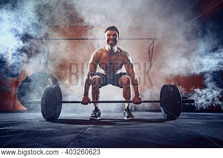 Muscular Fitness Man Doing Deadlift A Barbell Over His Head In Modern Fitness Center. Functional Tra