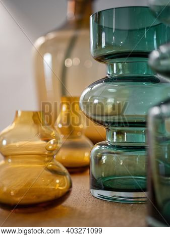 Close-up Of Stylish Decorative Vases From Transparent Glass On Wooden Table. Interior Decoration
