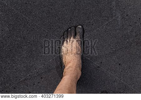 Male Barefoot On The Volcanic Black Sand On The Tenerife Beach