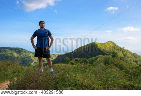 Man Trekker On Mountain Landscape Background. Summer Countryside Hiking Trail View With Male Tourist