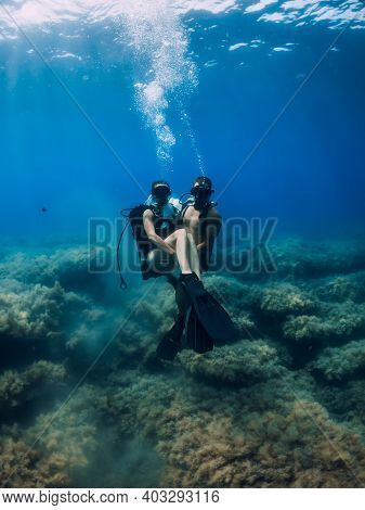 August 20, 2020. Anapa, Russia. Couple Of Scuba Divers Glides Underwater In Transparent Blue Sea. Sc