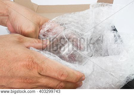 Hand Of Man Hold Bubble Wrap Cover Glass For Protection Product Cracked Or Insurance During Transit