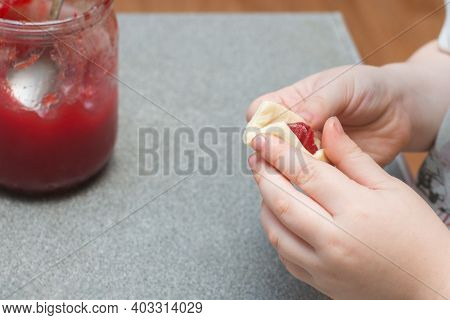 Close-up Of A Child's Hand Makes A Pie With Jam. Horizontal Photo. The Concept Is An Interesting, Ex