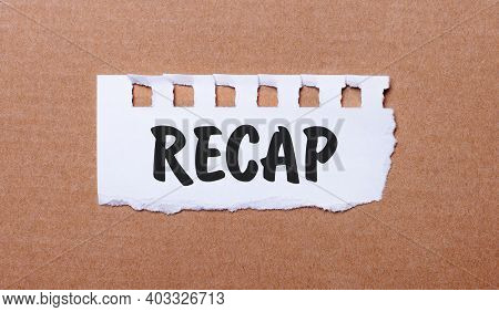 On A Brown Background, White Paper With The Inscription Recap