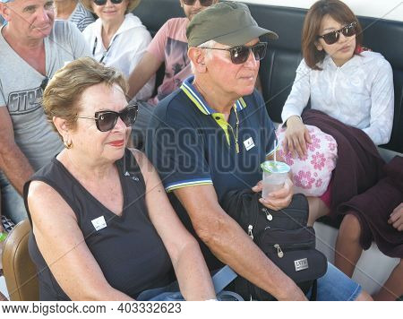 Pair Of Senior Couples Enjoying An Event With Other People. Smiling Mature Caucasian Couple Husband 