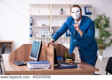 Young male employee wearing mask in the office