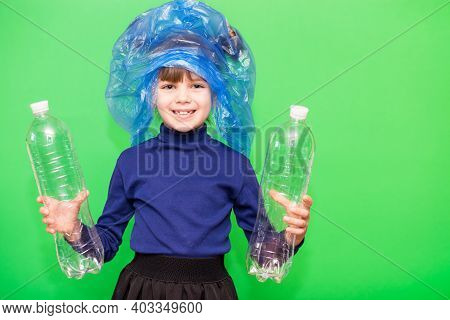 Girl Hold Trash Bag And Plastic Bottle And Shows Interest In Environmental Issues Isolated On Green 