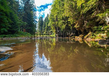 A Tiny River In The Mountain Forest With Low Water Waterfall. Brite Summer Day In Mountain Forest.