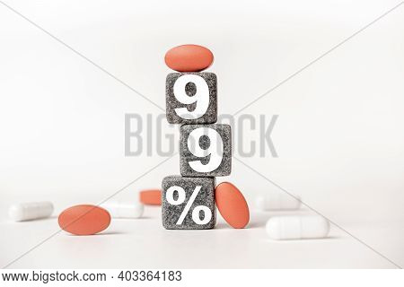 A Group Of White And Red Pills And Cubes With The Word 99 Persent On Them, White Background. Concept