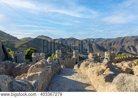 Interior Of A Medieval Fortress Facing The Mountains With Defense And Surveillance Towers Located In