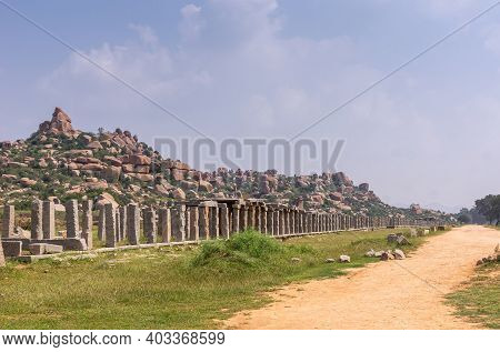 Hampi, Karnataka, India - November 5, 2013: Yellow Path Leading To Vijaya Vitthala Temple. Row Of Gr