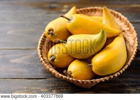 Eggfruit Or Canistel In A Basket On Wooden Table, Thai Fruit, In Thai Names Such As Xiantao, Lamut K