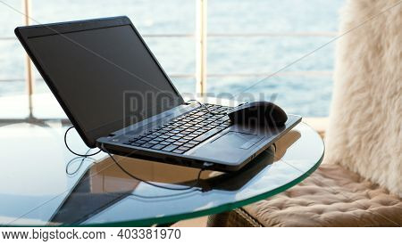 Laptop On The Table On The Hotel Balcony With Sea View. Remote Work, Doing Business On Vacation. Fas