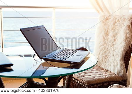 Laptop On The Table On The Hotel Balcony With Sea View. Remote Work, Doing Business On Vacation. Fas