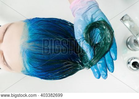 Washing Of Woman Hair With Conditioner Shampoo In Sink With Special Shower. Top View Of Hairstylist 
