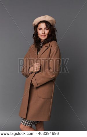 Young Elegant Woman In Stylish Spring Outfit Isolated On The Grey Background. Model Woman In Dress, 