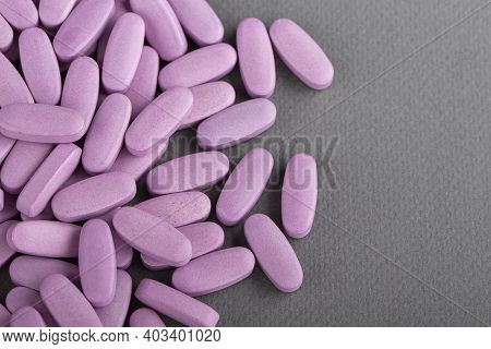 Heap Of Pink Medical Pills On A Gray Background. Health Concept. Top View.