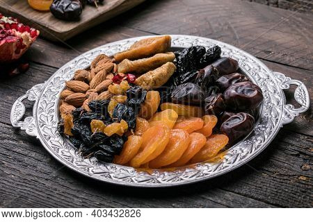 Assortment Of Nuts And Dried Fruits. Dried Fruits And Nuts Mix In A Wooden Bowl. Assortment Of Candi