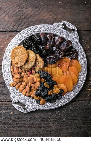 Dried Fruits And Nuts Mix In A Wooden Bowl. Assortment Of Candied Fruits. Judaic Holiday Tu Bishvat.