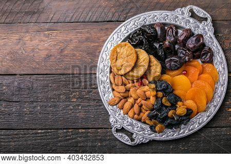 Dried Fruits And Nuts Mix In A Wooden Bowl. Assortment Of Candied Fruits. Judaic Holiday Tu Bishvat.