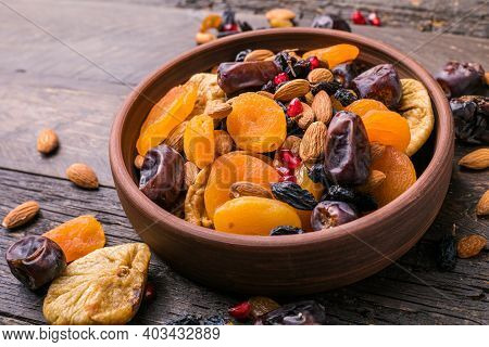 Dried Fruits And Nuts Mix In A Wooden Bowl. Assortment Of Candied Fruits. Judaic Holiday Tu Bishvat.