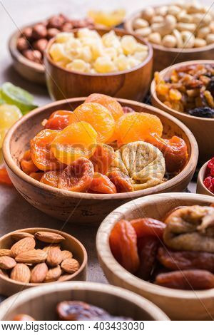 Assortment Of Nuts And Dried Fruits. Dried Fruits And Nuts Mix In A Wooden Bowl. Assortment Of Candi