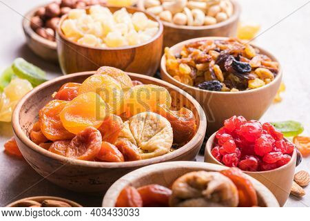 Assortment Of Nuts And Dried Fruits. Dried Fruits And Nuts Mix In A Wooden Bowl. Assortment Of Candi