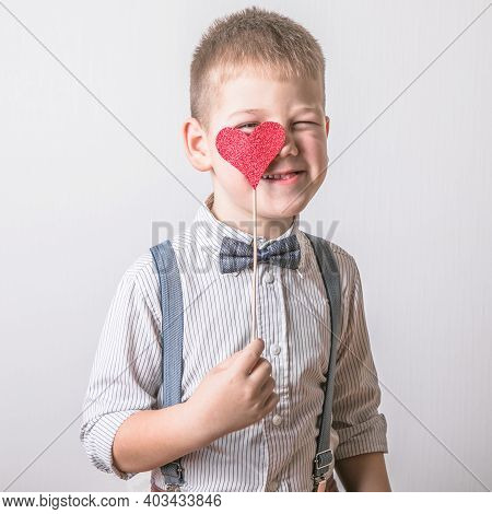 Five Year Old Smiling Boy Holding A Red Heart On Eays  Symbol Of Love, Family, Hope. Backgrounds For