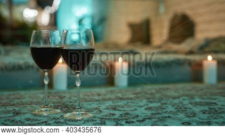 Romantic Evening At Home. Wine Glasses On The Floor With Candles On The Background, Selective Focus.