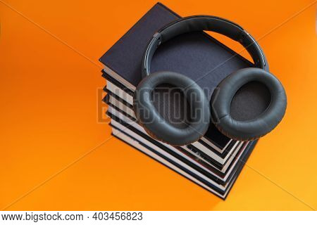 Audiobooks.reading. Training And Knowledge. Distance Education. A Stack Of Books And Headphones On A