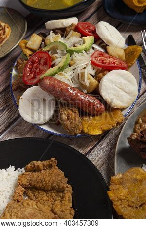Variety Of Typical Dishes Of Colombian Gastronomy. Picada, Tripe, San Cocho, Paisa Tray.