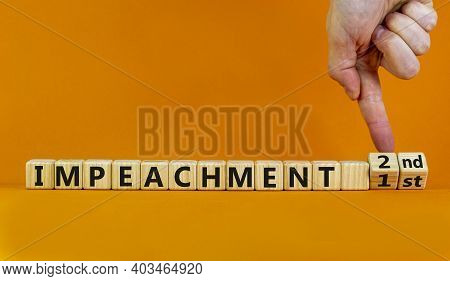 Second Impeachment Symbol. Businessman Turns Wooden Cubes And Changes Words 1st Impeachment To 2nd I